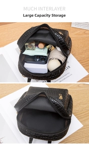 Detail view of mini black crocodile texture backpack with multi-compartment storage space