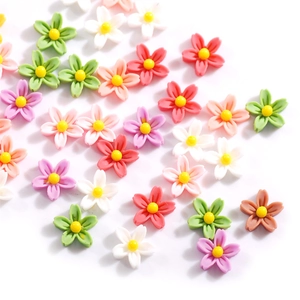 Macro detail of colorful resin cherry blossom nail art charms in pink, purple and white