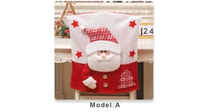 Detail of 3D knitted Santa Claus chair cover with festive tree and pom-pom accents