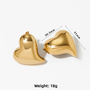 Detailed view of large gold heart earrings with 31mm size and polished finish
