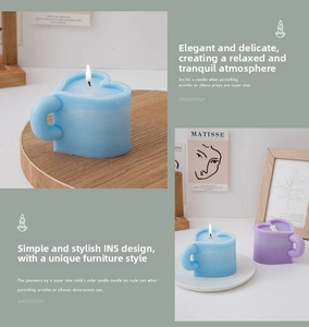 Detail of heart-shaped scented candles in light blue and purple on a stylish wooden tray