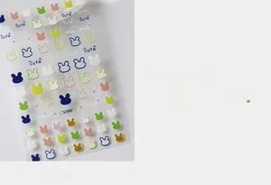 Close-up of cute cartoon rabbit nail art stickers with colorful patterns and letters