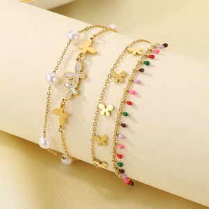 Close-up of double-layer 18K gold plated butterfly anklet with pearls and shell charm