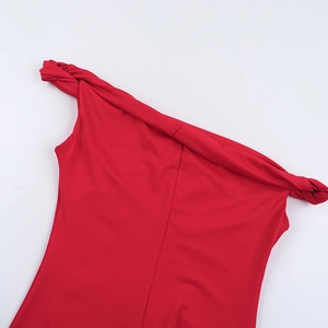 Detail shot of elegant red off-shoulder neckline with twisted knot design on smooth fabric