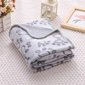 Detail of soft grey flannel pet blanket with paw prints and reinforced stitched edges