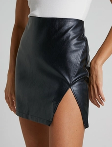 Detail shot of black PU leather high waist mini skirt featuring a stylish side slit design
