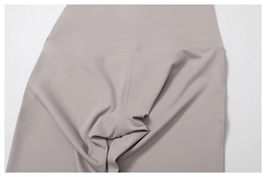 Detail of high-waist yoga flare pants showing durable flatlock stitching and grey fabric