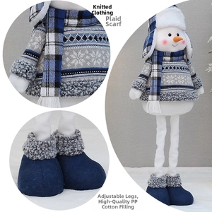 Detail of extendable legs on blue fabric snowman doll with knit clothes and plaid scarf