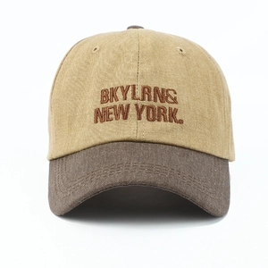 Frontal view of a washed cotton baseball cap featuring brown New York embroidery details