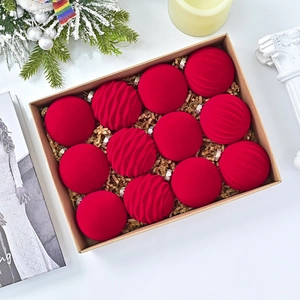 Detailed set of 12 red flocked velvet Christmas ornaments with embossed wavy patterns in box