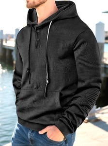 Close-up of black hoodie with herringbone texture, drawstring hood and neck buttons