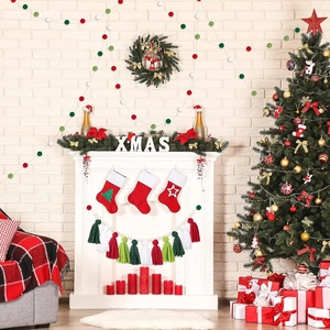 Christmas fireplace scene featuring red, green and white felt ball garland decoration
