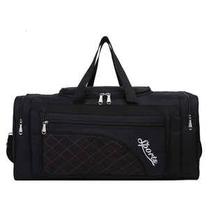 Detail of black Oxford travel bag featuring orange diamond stitching and side buckles