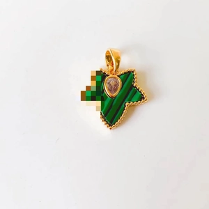 Detail of maple leaf pendant with 18k gold frame, green malachite, and clear gemstone
