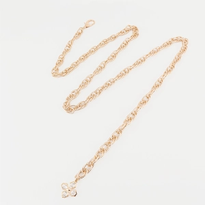 Golden woven waist chain with sparkling clover pendant and crystals on white background