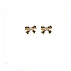 Detail of vintage bow earrings with pearls and rhinestones on 925 silver pins
