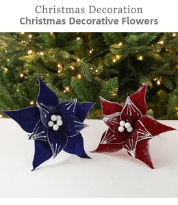 Close-up of velvet artificial Christmas flowers in navy and red with snowy glitter detail