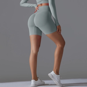Detail view of high waisted scrunch butt yoga shorts in morandi green seamless fabric