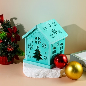 Detail of Christmas house candle holder with cutout snowflake and tree patterns