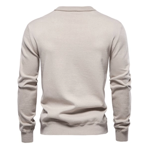 Detail view of beige knit sweater back showing fine texture and premium stitching