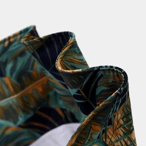 Gros plan du motif de feuilles tropicales et coutures sur le tissu du chapeau d'été