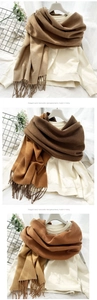 Detail of elegant two-tone pashmina scarf featuring long tassels and soft knitted texture