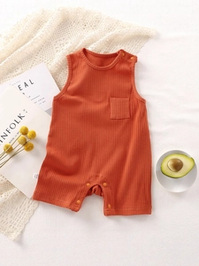 Breathable sleeveless baby romper in burnt orange knit cotton with shoulder snaps