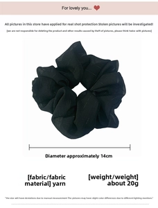 Detailed close-up of a 14cm oversized black sheer fabric scrunchie with soft pleats