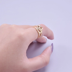 Close-up of golden double heart open ring featuring a hollow layered design on finger