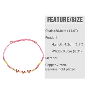 Detail view of pink braided heart bracelet with colorful zircons and gold beads