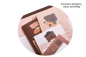 Close-up of cute cookie bear notepad showing grid and lined pages for journaling