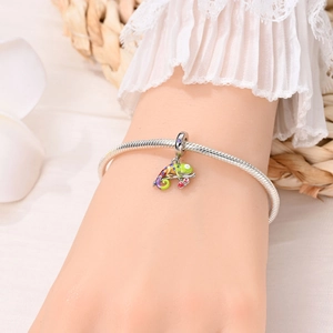 Close-up of a hand wearing a silver snake chain bracelet with a colorful chameleon charm