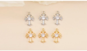 Detailed view of metal cross charms with zircon insets for DIY jewelry making