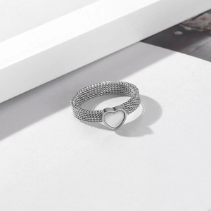 Detailed view of silver mesh band ring featuring a heart-shaped pearl shell inlay