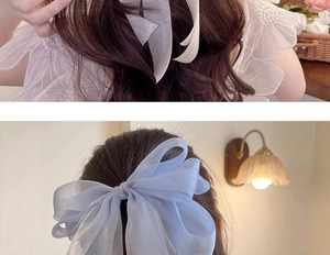 Detail of oversized organza bow clips in white and light blue for elegant hairstyles