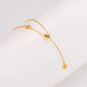 Elegant gold stainless steel waist chain necklace with coin pendants on a curved background