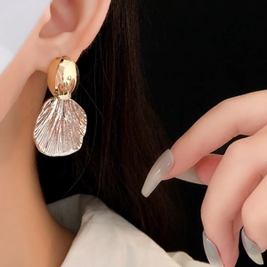 Gold plated fan-shaped shell earrings with textured metallic finish and silver pin
