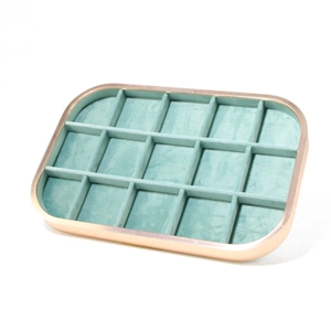 Detail of 18-grid rose gold metal jewelry tray with cyan velvet lining for display
