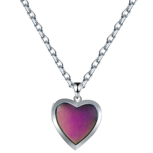 Macro detail of heart locket pendant with color-changing surface on silver O-chain