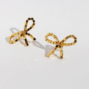 Minimalist golden cube bead bow earrings with shiny metallic finish on white background