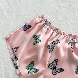 Pink satin pajama shorts with colorful butterfly prints and comfortable elastic waistband
