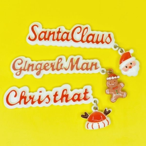 DIY Christmas resin charms featuring Santa Claus, Gingerbread Man, and hat on yellow base