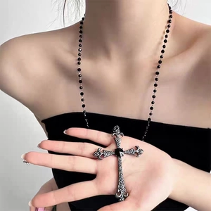 Gothic black beaded necklace with a dark cross pendant featuring a centered black gemstone