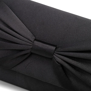 Close-up of black satin clutch bag showing pleated butterfly knot detail and smooth texture