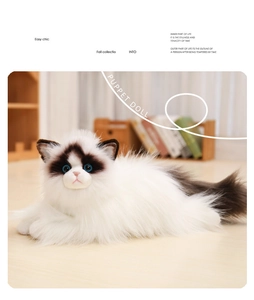 Close-up of realistic plush ragdoll cat toy with soft white fur and blue eyes