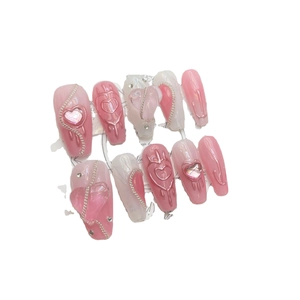 Handmade pink heart press-on nails with 3D pearls and silver chains in long coffin shape