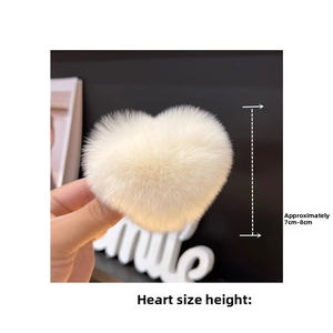 Detailed view of large white heart-shaped faux fur hair clip measuring 7-8cm in height