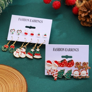 Christmas earring set with Santa, snowflake, reindeer, and tree on festive green velvet