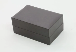 Detail of a dark gray rectangle PU leather watch box with a classic flip-top lid design