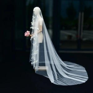 Detail of 3m bridal veil featuring 3D floral appliqués and pearls on white mesh